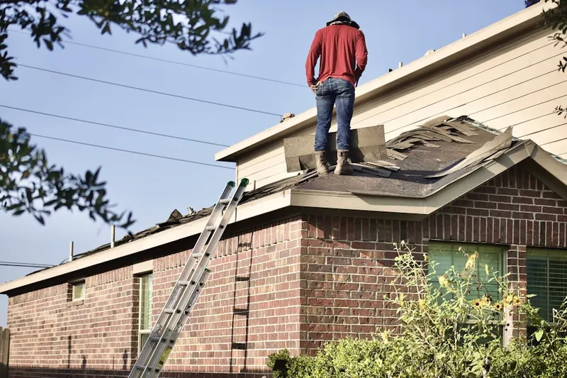 Professional roofer working on a residential roof in Nautilus